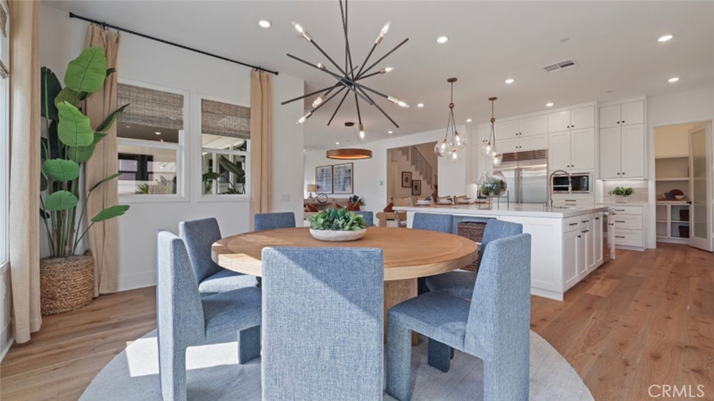 21381 Cloud Ridge Yorba Linda, CA 92887 - Photo 7 of 38 a open kitchen with stainless steel appliances granite countertop a stove refrigerator dining table and chairs