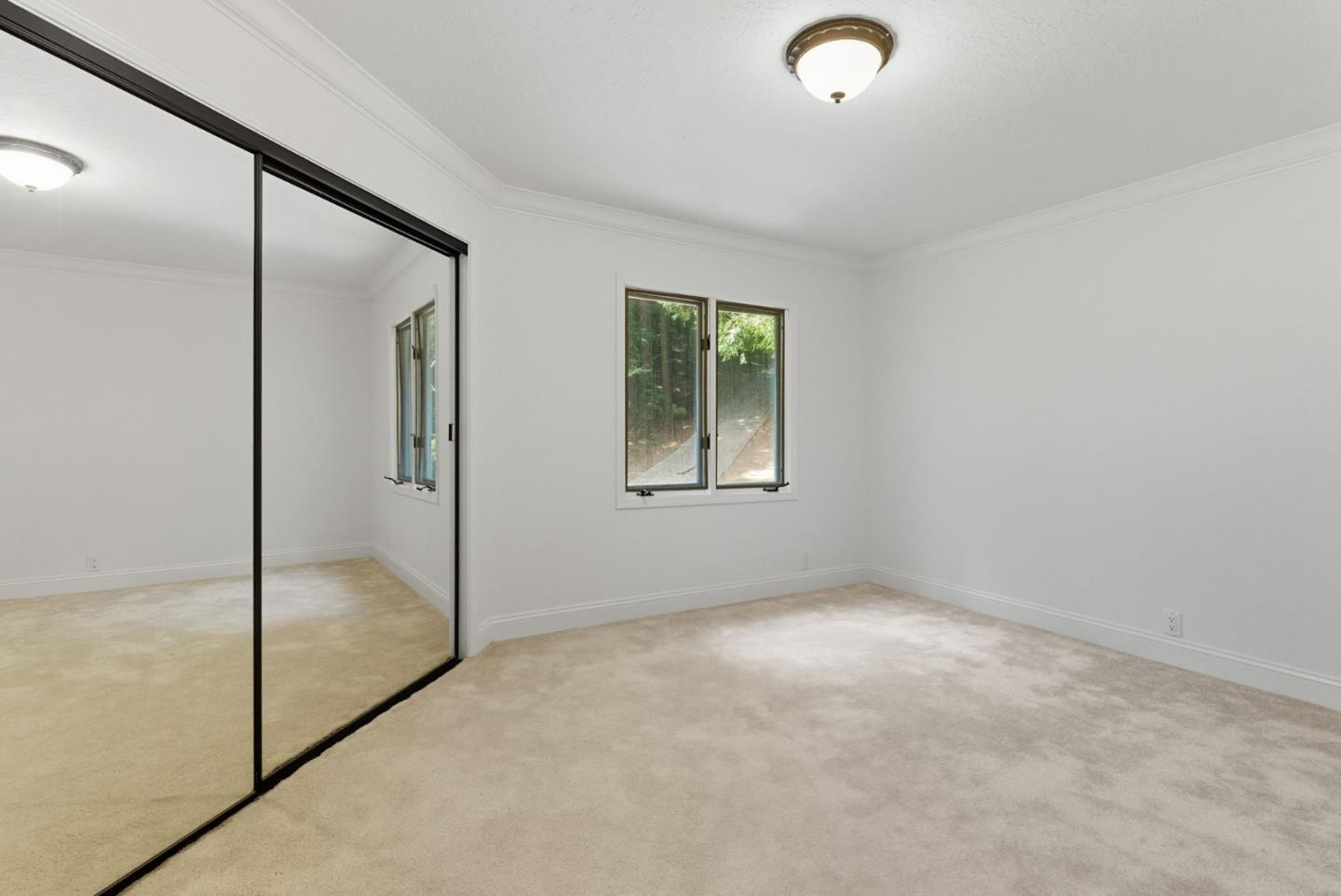 23489 Hutchinson Road Los Gatos, CA 95033 - Photo 24 of 46 an empty room with windows and closet