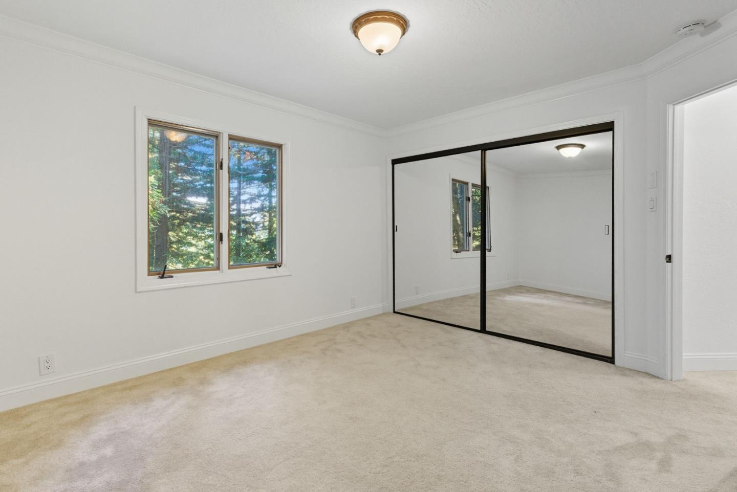 23489 Hutchinson Road Los Gatos, CA 95033 - Photo 25 of 46 an empty room with windows and closet