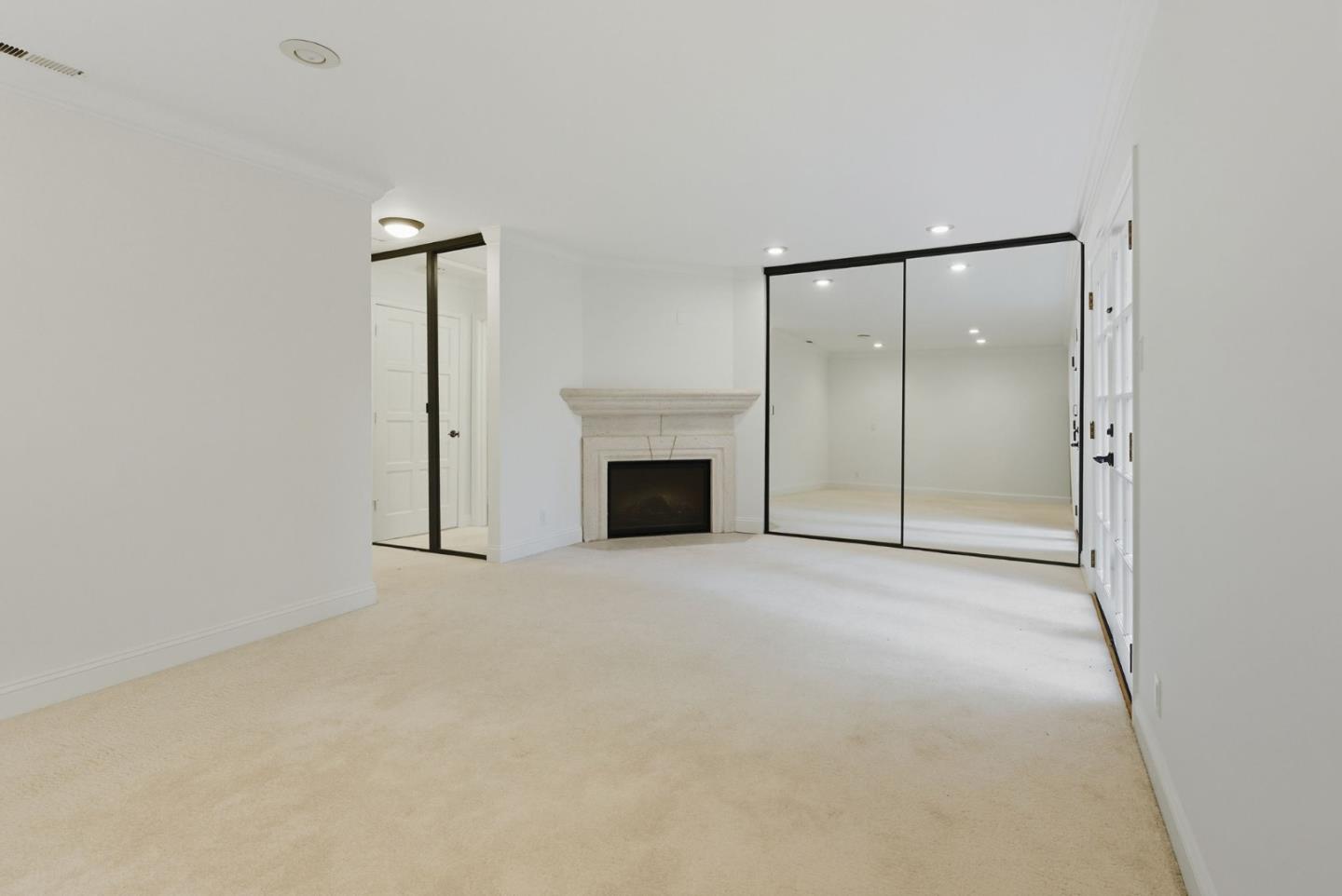 23489 Hutchinson Road Los Gatos, CA 95033 - Photo 28 of 46 an empty room with fireplace and a ceiling fan
