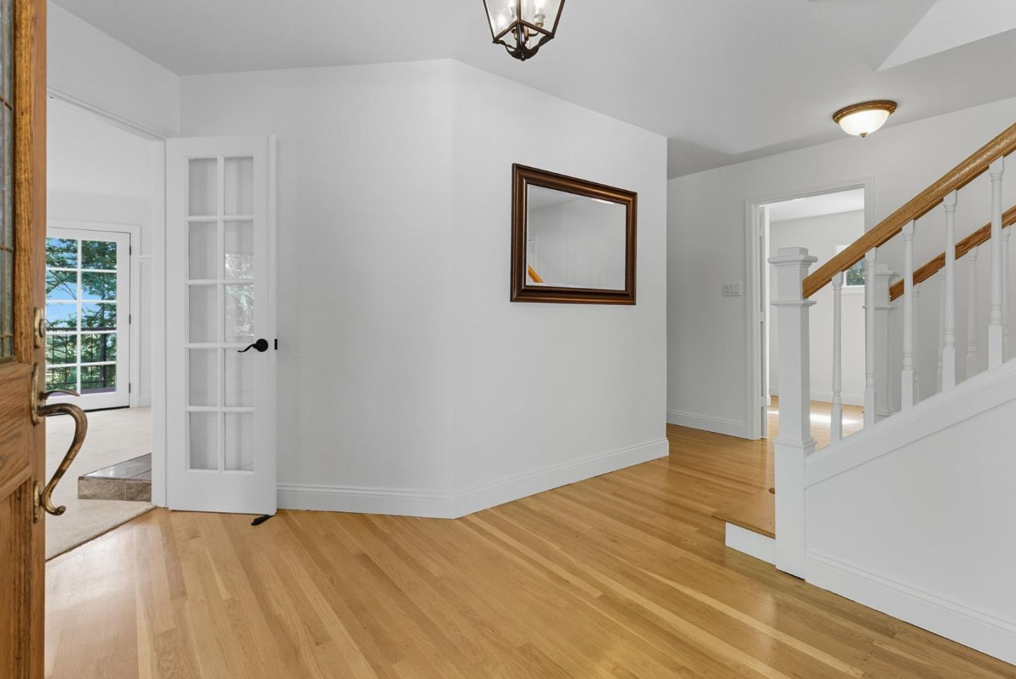 23489 Hutchinson Road Los Gatos, CA 95033 - Photo 4 of 46 a view of a livingroom with wooden floor and white walls