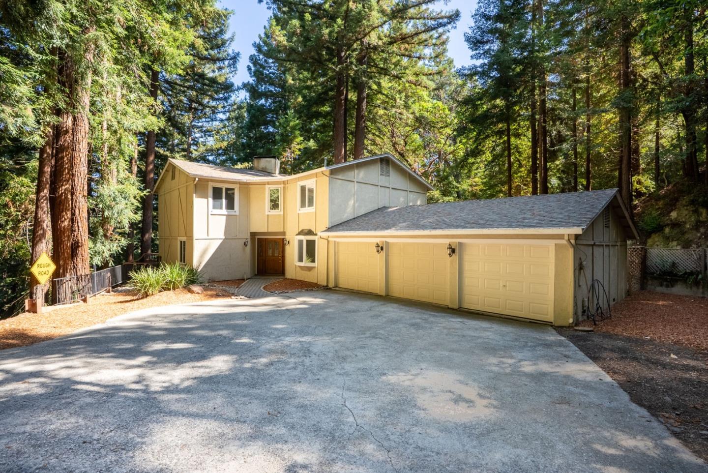 23489 Hutchinson Road Los Gatos, CA 95033 - Photo 44 of 46 a view of a house with a yard and garage