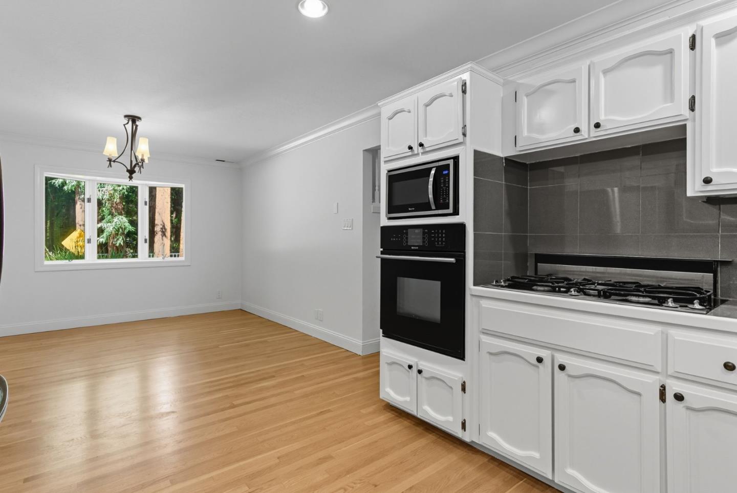 23489 Hutchinson Road Los Gatos, CA 95033 - Photo 6 of 46 a kitchen with stainless steel appliances white cabinets and a stove top oven