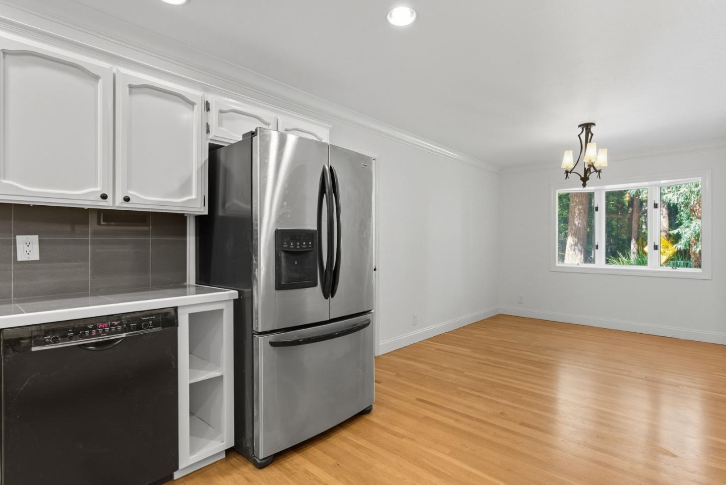 23489 Hutchinson Road Los Gatos, CA 95033 - Photo 7 of 46 a kitchen with stainless steel appliances granite countertop a refrigerator a stove and a sink with wooden floor