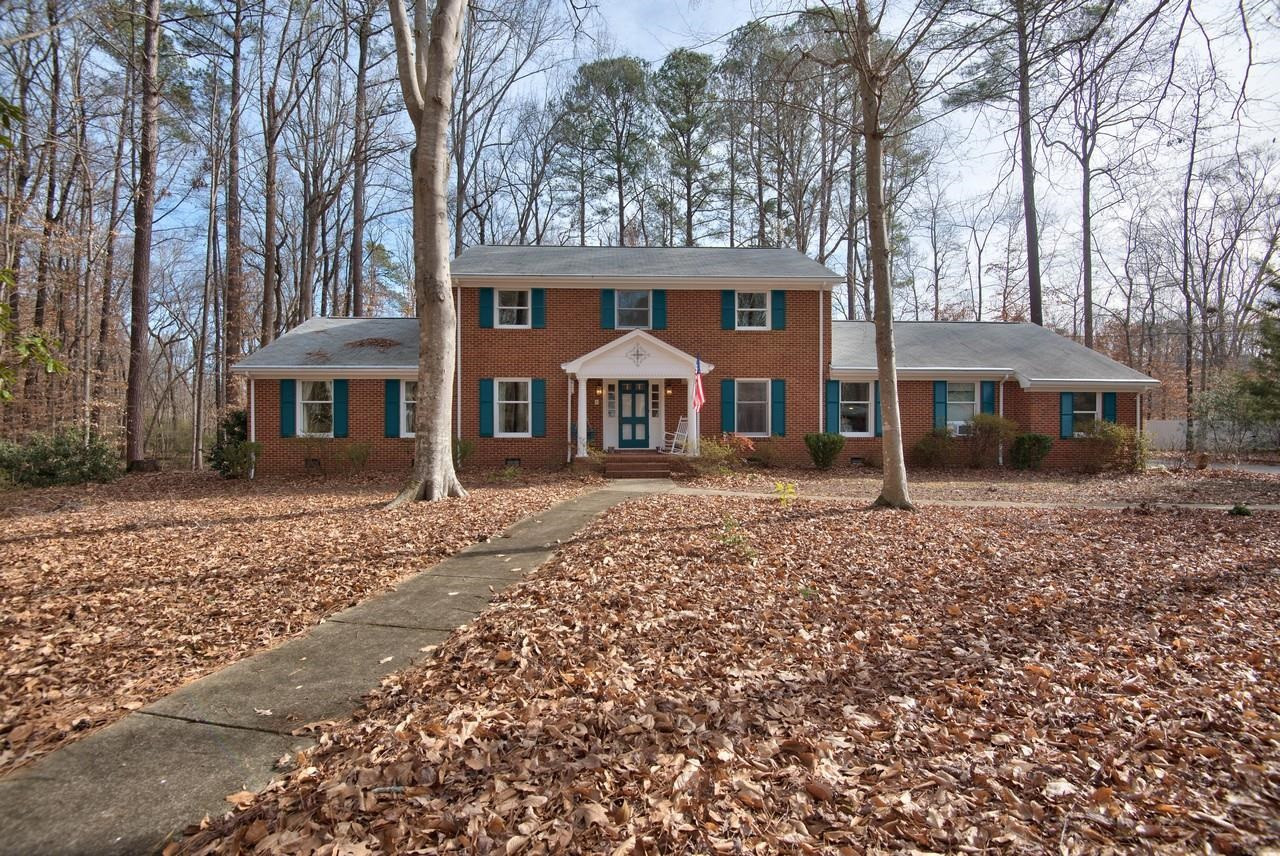 front view of a house with a tree