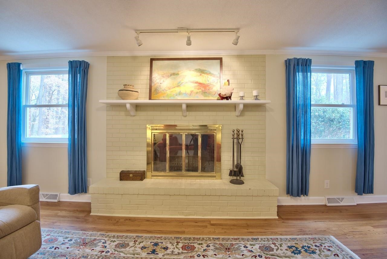 3563 Hamstead Court Durham, NC 27707 - Photo 13 of 37 a living room with a fireplace windows and wooden floor