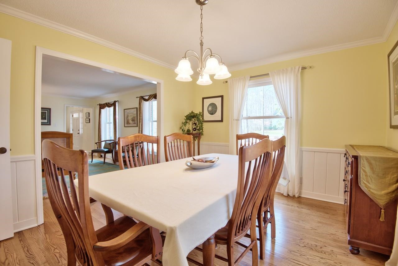 3563 Hamstead Court Durham, NC 27707 - Photo 15 of 37 a view of a dining room with furniture window and wooden floor