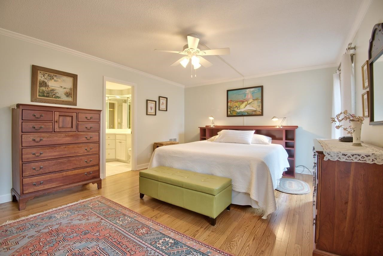 3563 Hamstead Court Durham, NC 27707 - Photo 18 of 37 a spacious bedroom with a bed and a chandelier
