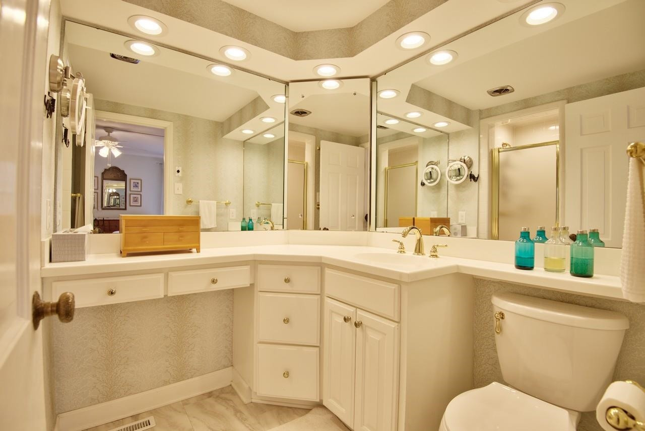 3563 Hamstead Court Durham, NC 27707 - Photo 21 of 37 a bathroom with a sink a toilet a mirror a vanity and shower