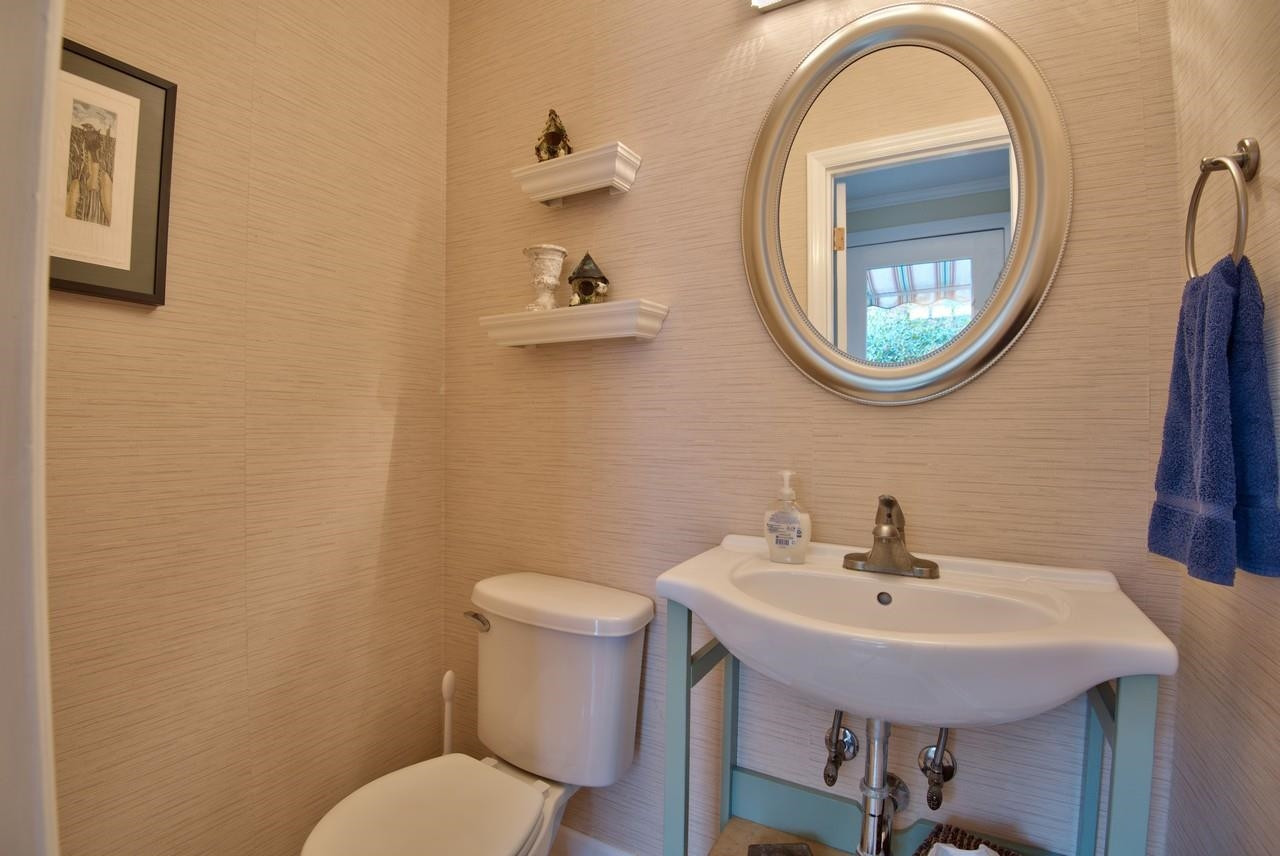 3563 Hamstead Court Durham, NC 27707 - Photo 25 of 37 a bathroom with a toilet a sink and a mirror