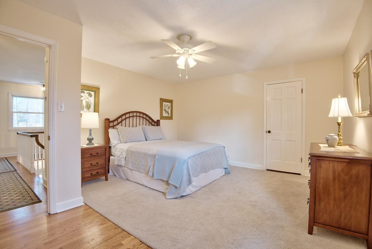 3563 Hamstead Court Durham, NC 27707 - Photo 26 of 37 a bedroom with a bed and a chandelier