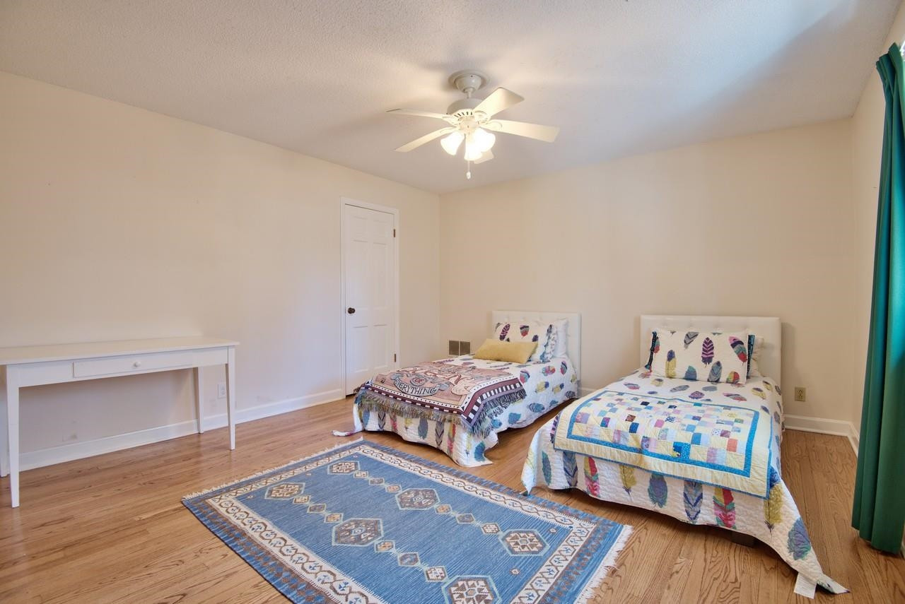 3563 Hamstead Court Durham, NC 27707 - Photo 29 of 37 a bedroom with two beds and a chandelier