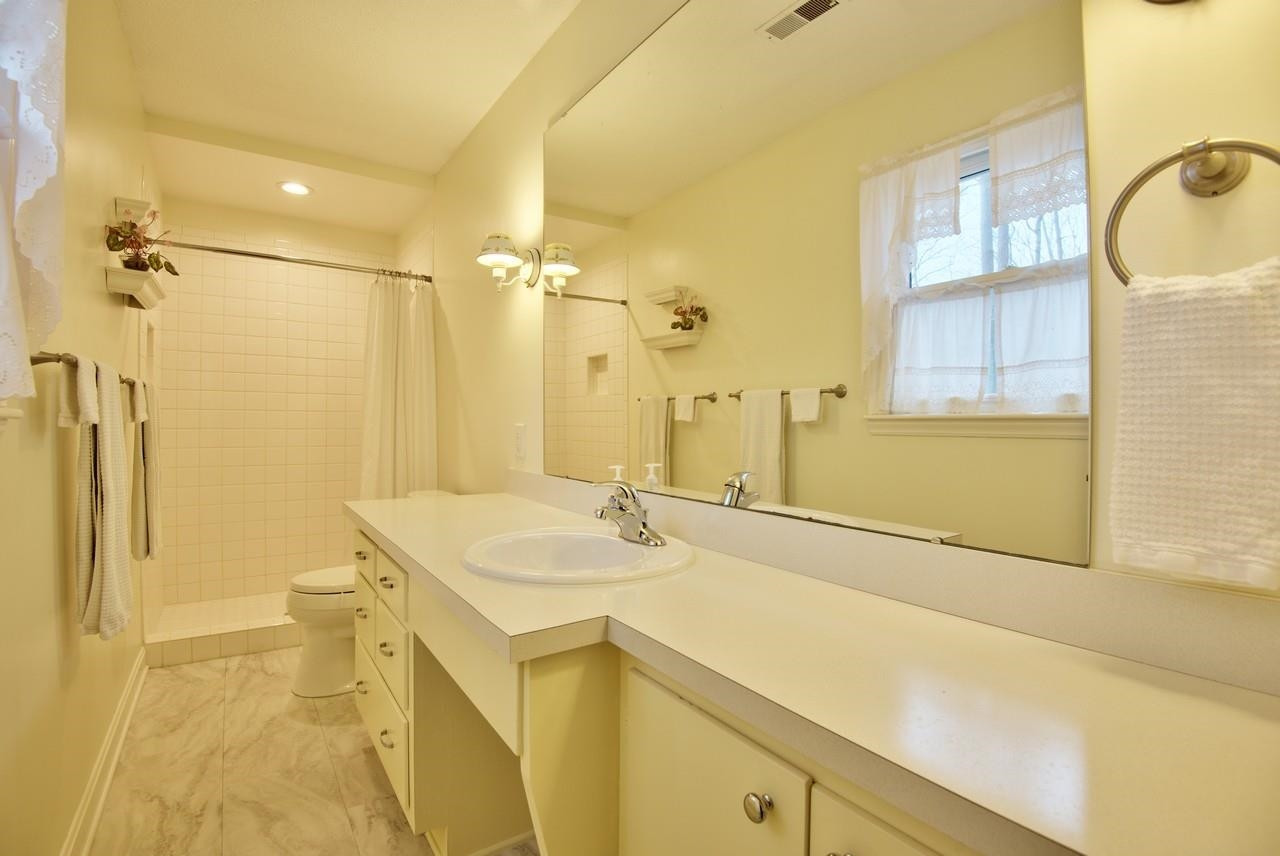 3563 Hamstead Court Durham, NC 27707 - Photo 30 of 37 a bathroom with a sink and a mirror
