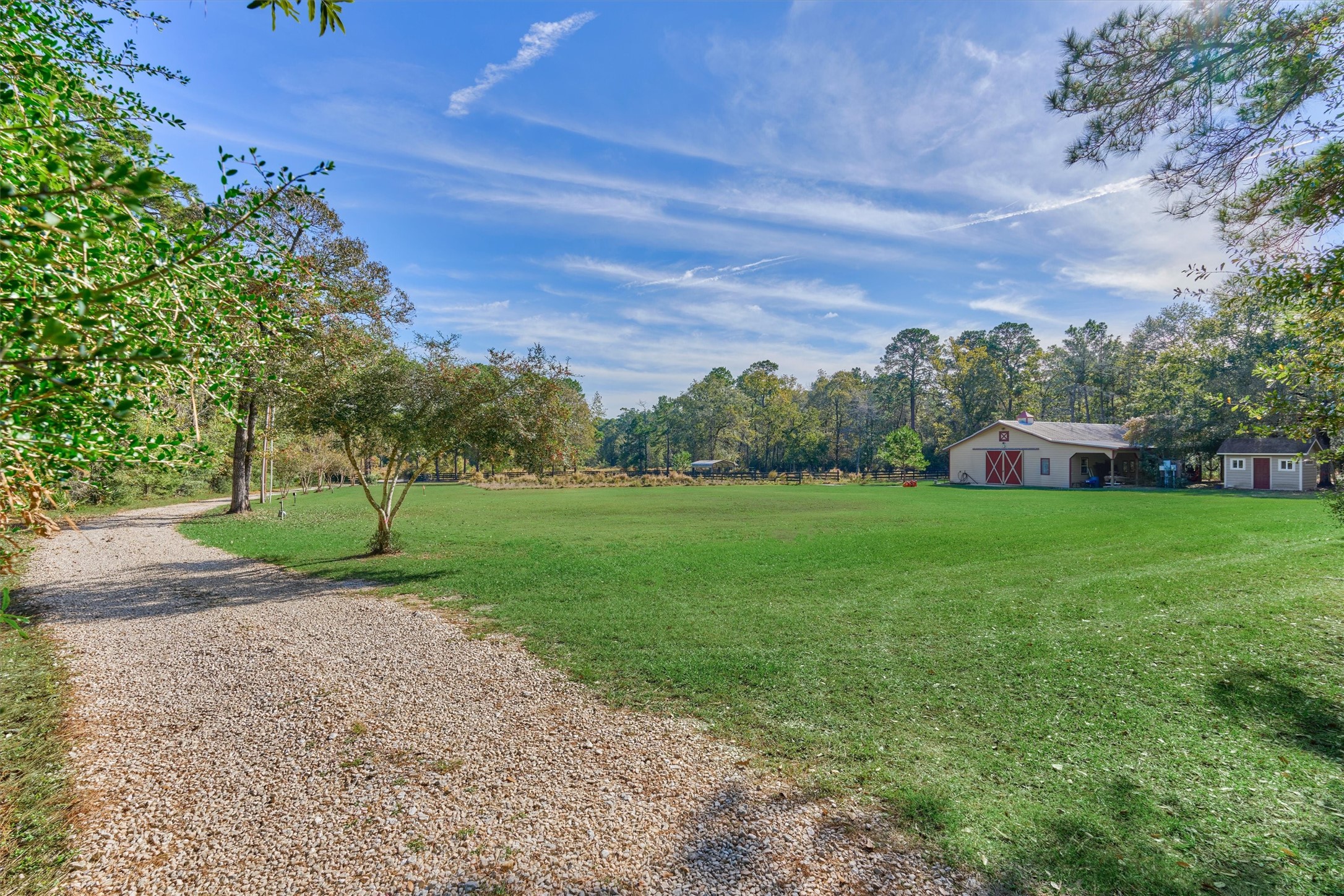 0 Koenig Lane Conroe, TX 77384 - Photo 5 of 19 View from the west end of the driveway looking back towards the lot.
