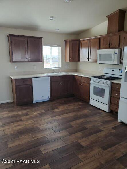 425 West Antelope Run Road Paulden, AZ 86334 - Photo 7 of 16 a kitchen with stainless steel appliances granite countertop a stove a sink and a microwave