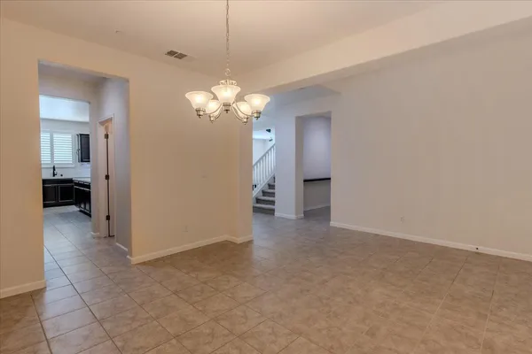 a view of a chandelier in big room and a bathroom