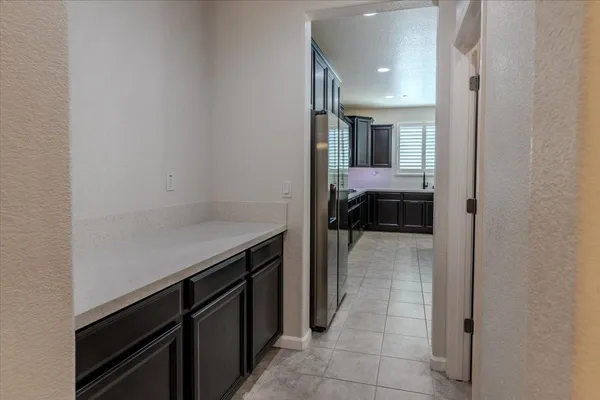 a view of a hallway and a livingroom with furniture