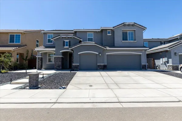 a front view of a house with a yard