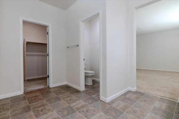 a view of a bathroom with a toilet and a shower