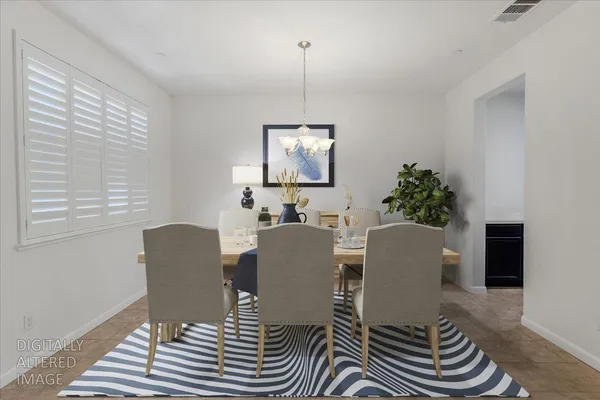 a dining room with furniture a window and wooden floor