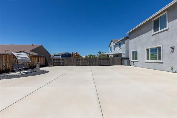 a view of a house with wooden fence