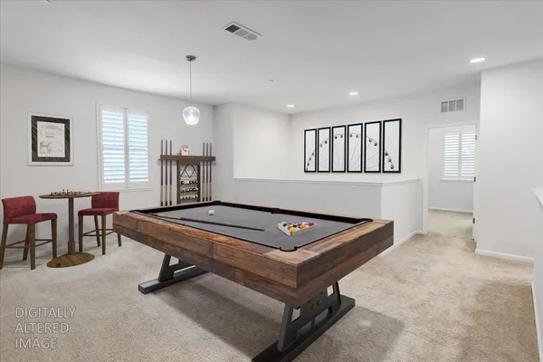 a room with furniture pool table and windows