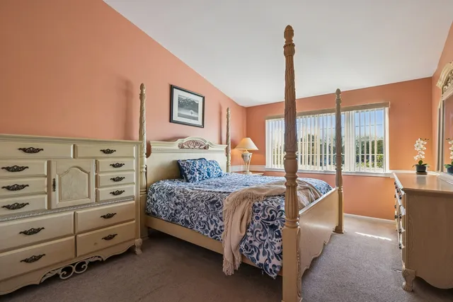 a bedroom with furniture and large window
