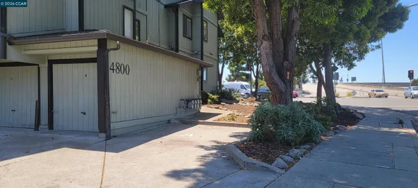 a view of a entrance gate of the house and trees