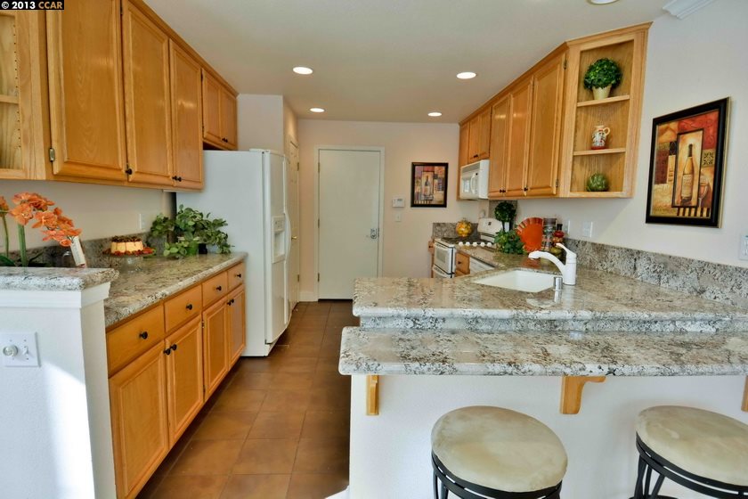 112 Coralflower Lane San Ramon, CA 94582 - Photo 8 of 21 a kitchen with stainless steel appliances granite countertop a sink a stove and a wooden cabinets