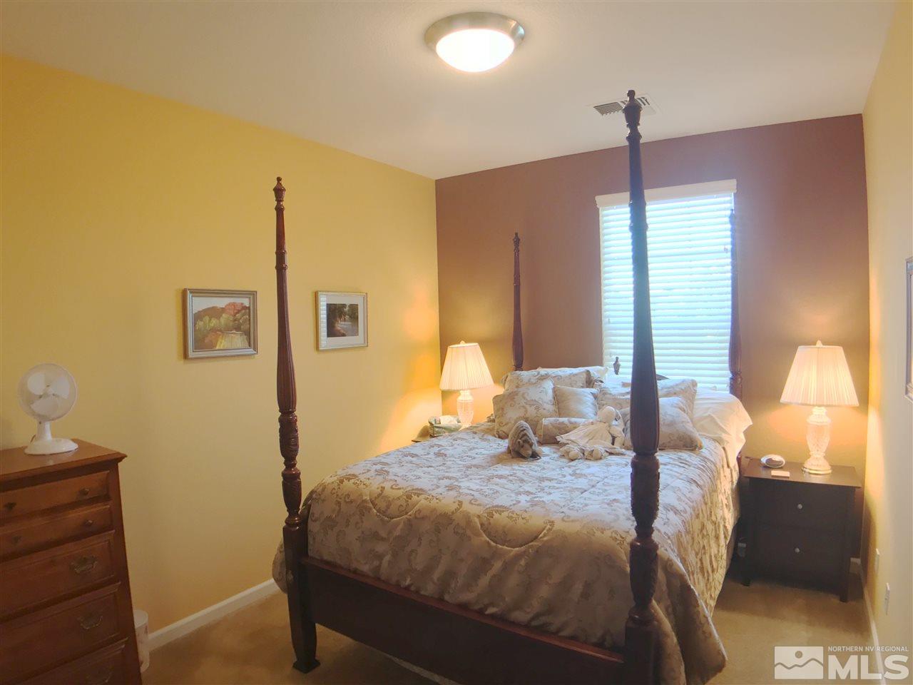 1924 Wind Ranch Road, Unit A Reno, NV 89521 - Photo 12 of 17 a bedroom with a bed and a dresser