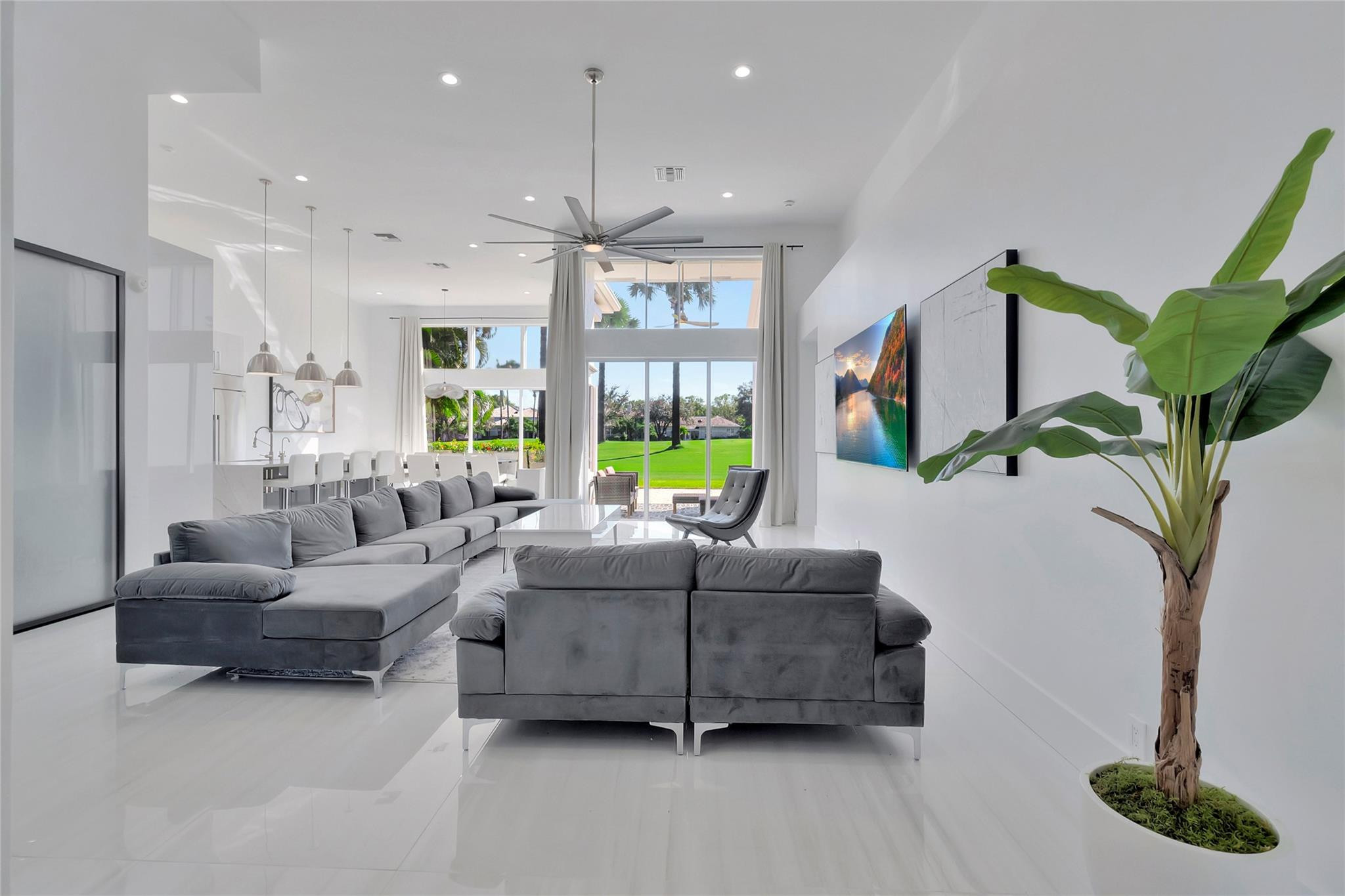 4088 Briarcliff Circle Boca Raton, FL 33496 - Photo 12 of 36 a living room with furniture a chandelier and a large window