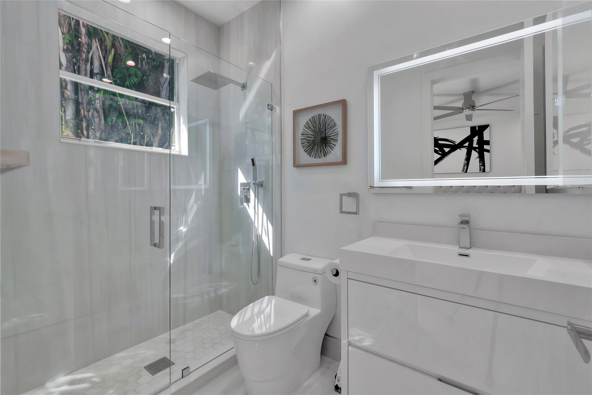 4088 Briarcliff Circle Boca Raton, FL 33496 - Photo 17 of 36 a bathroom with a sink a toilet and shower