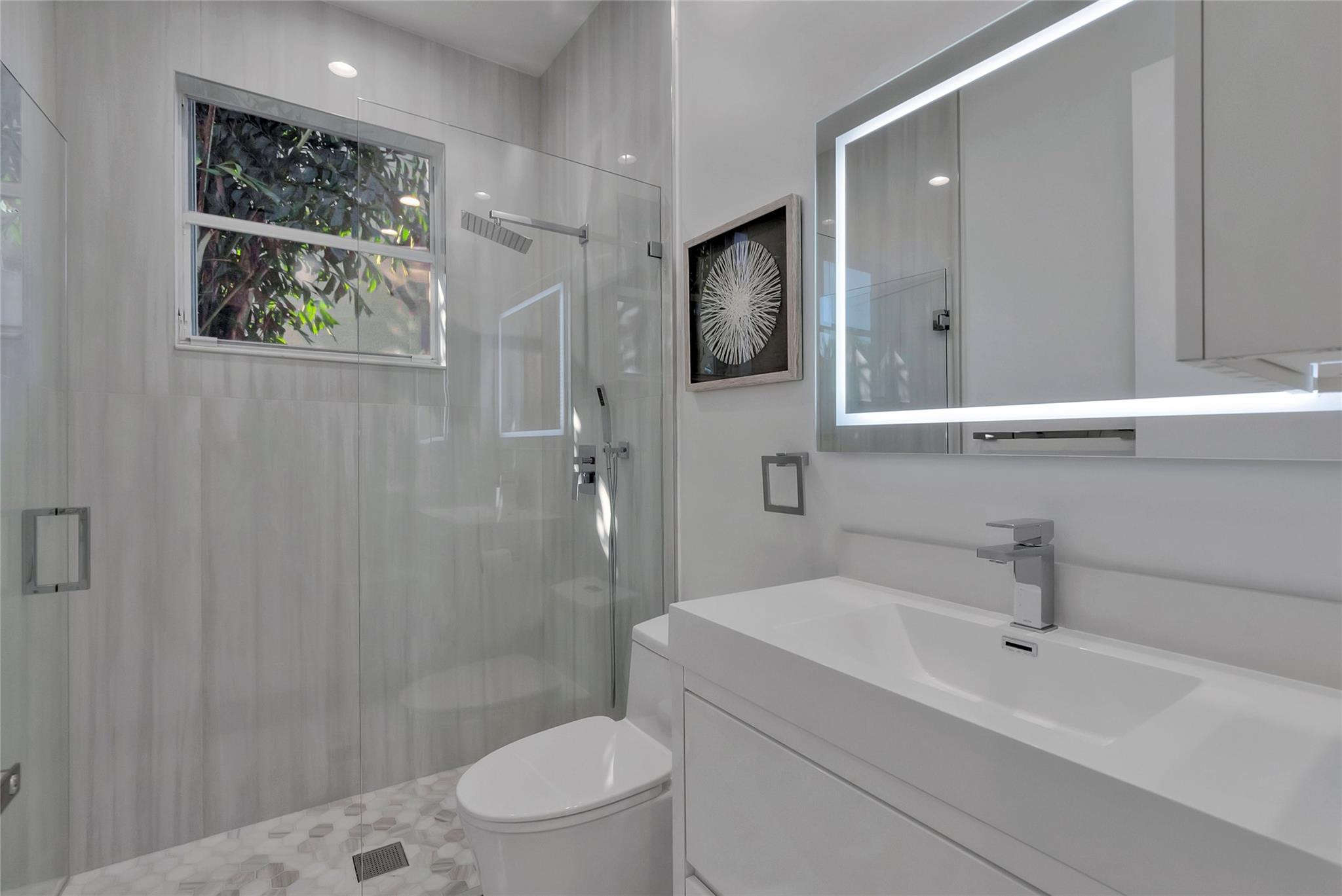 4088 Briarcliff Circle Boca Raton, FL 33496 - Photo 20 of 36 a bathroom with a sink a toilet and shower