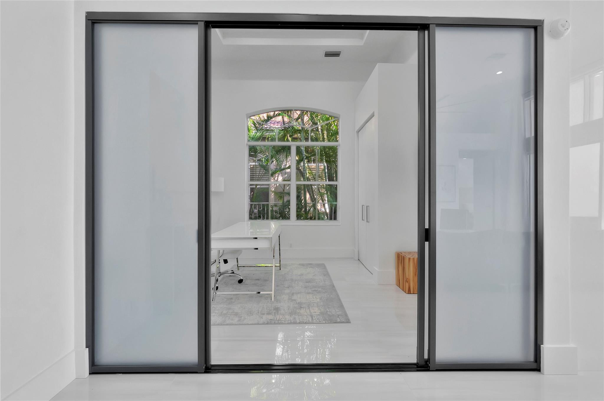 4088 Briarcliff Circle Boca Raton, FL 33496 - Photo 22 of 36 a view of a bedroom with wooden floor and a window