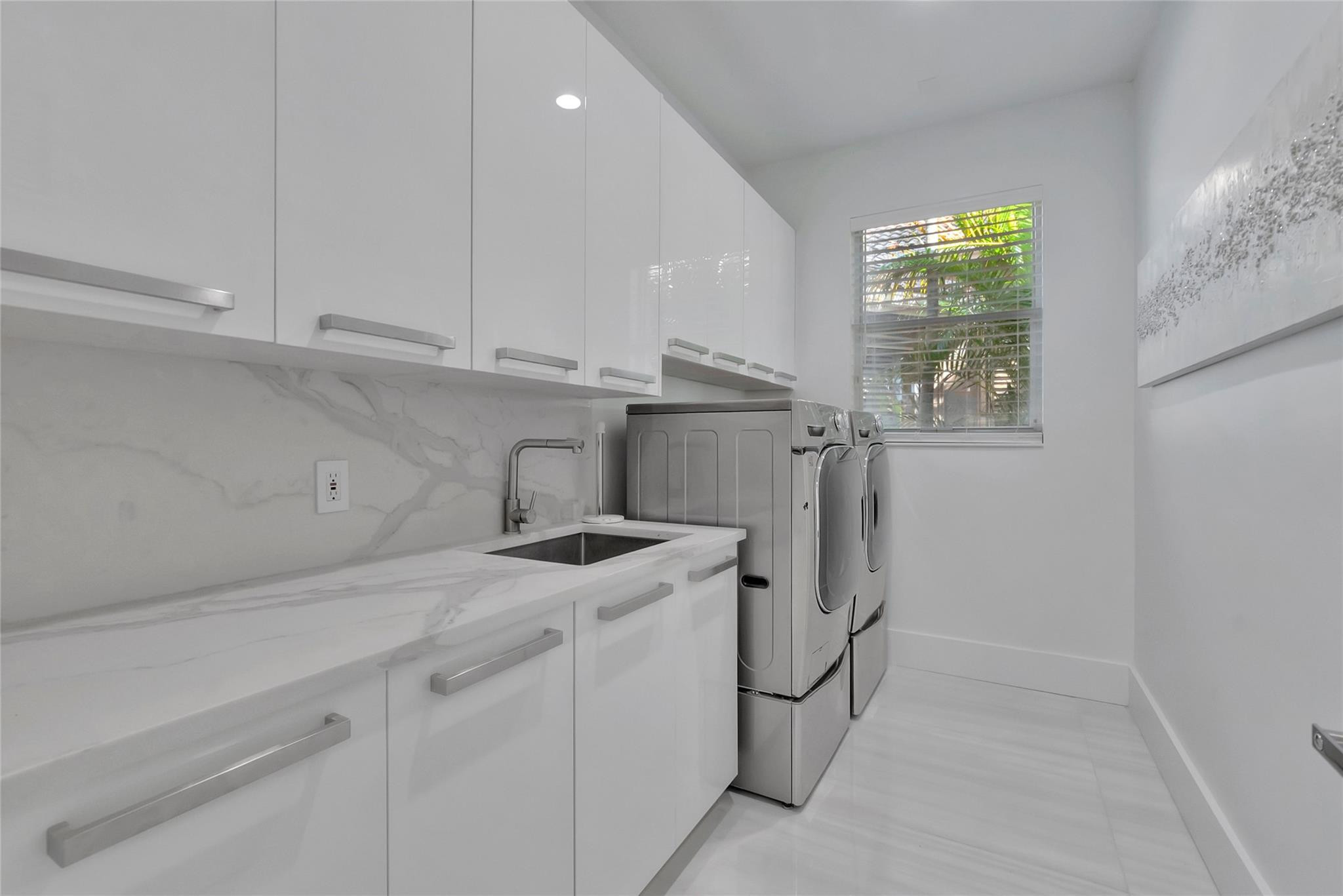 4088 Briarcliff Circle Boca Raton, FL 33496 - Photo 25 of 36 a utility room with cabinets washer and dryer