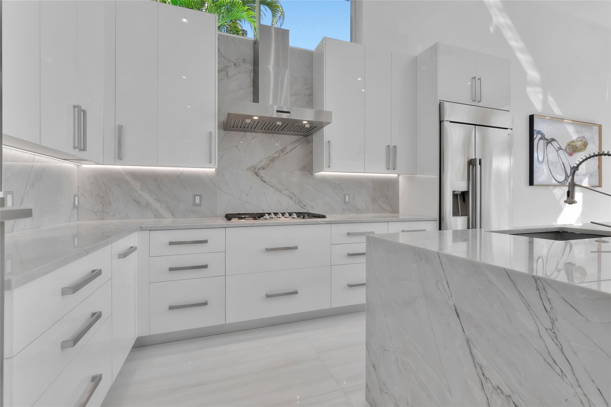 4088 Briarcliff Circle Boca Raton, FL 33496 - Photo 6 of 36 a view of a kitchen with white cabinets and stainless steel appliances