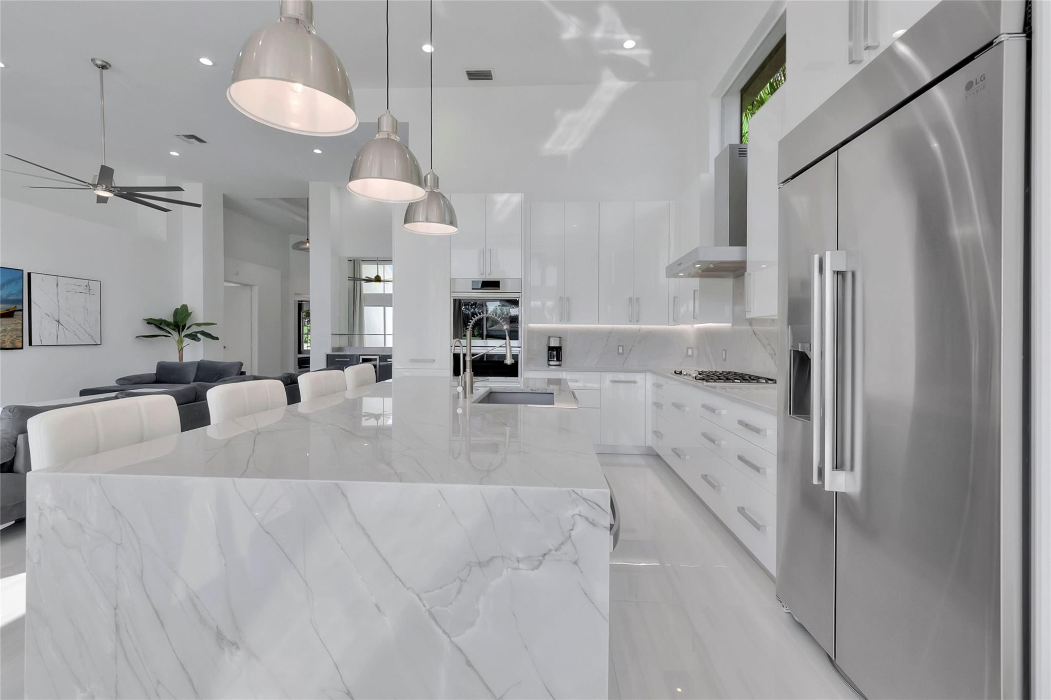 4088 Briarcliff Circle Boca Raton, FL 33496 - Photo 8 of 36 a large white kitchen with a refrigerator a sink and a large window