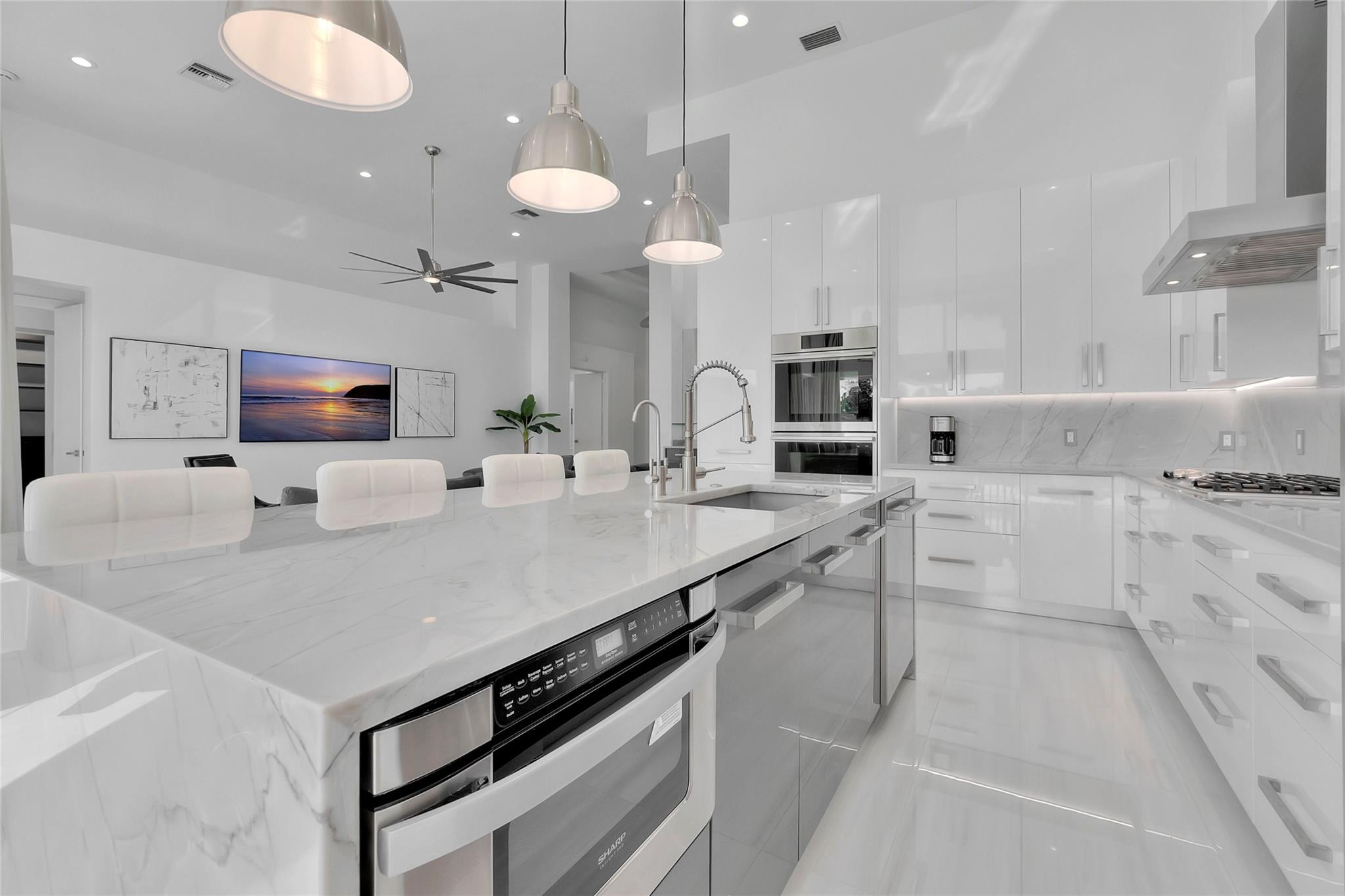 4088 Briarcliff Circle Boca Raton, FL 33496 - Photo 9 of 36 a kitchen with stainless steel appliances a sink a stove a counter space and cabinets