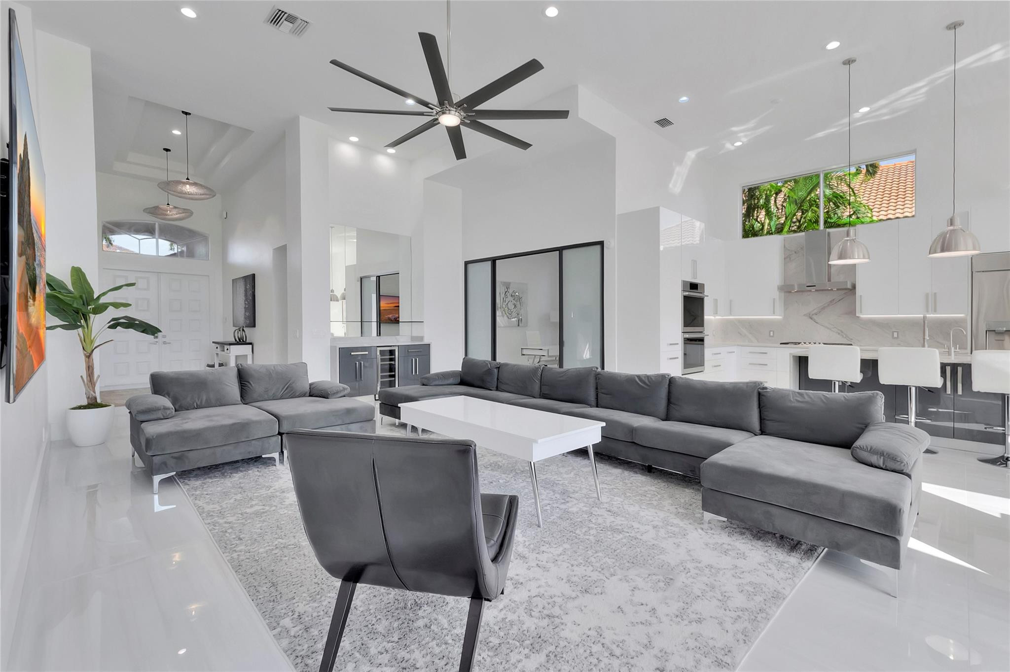 4088 Briarcliff Circle Boca Raton, FL 33496 - Photo 10 of 36 a living room with furniture and a chandelier