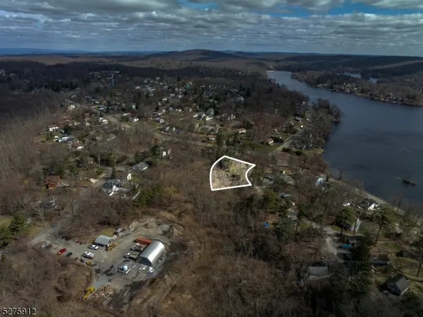 a view of a yard with wooden floor and a bench