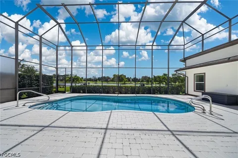 a view of swimming pool with seating in living room