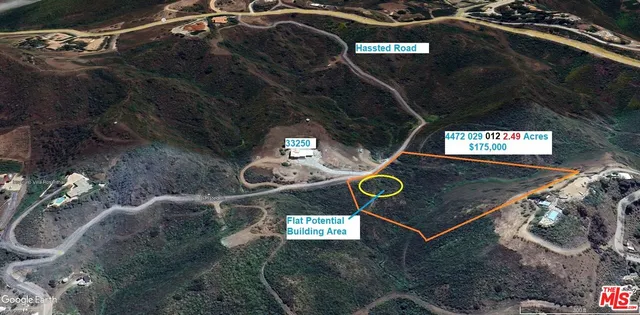 a view of a field with a mountain in the background