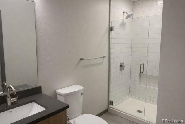 603 Inca Street, Unit 516 Denver, CO 80204 - Photo 15 of 15 a bathroom with a shower a toilet and sink
