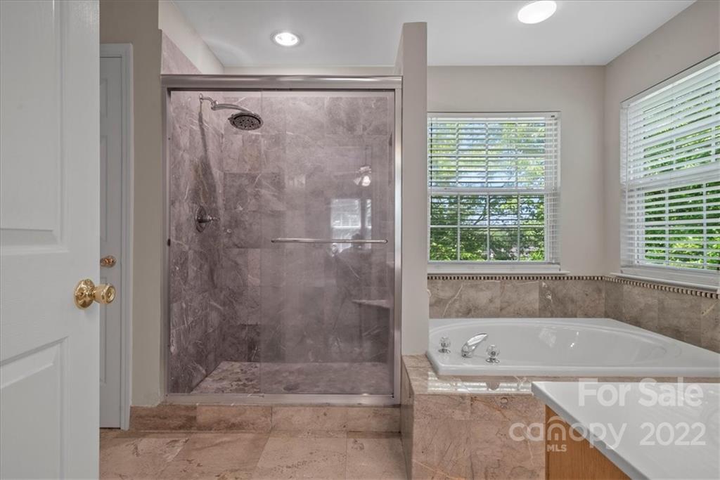 500 Haley Court Fort Mill, SC 29708 - Photo 13 of 20 a bathroom with a granite countertop bathtub shower and window