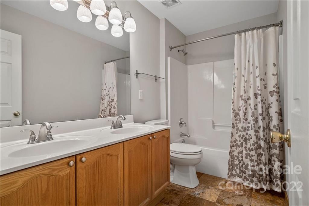 500 Haley Court Fort Mill, SC 29708 - Photo 16 of 20 a bathroom with a sink a toilet a mirror a vanity and shower