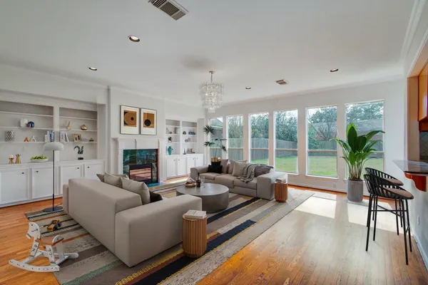 a living room with fireplace furniture and a wooden floor