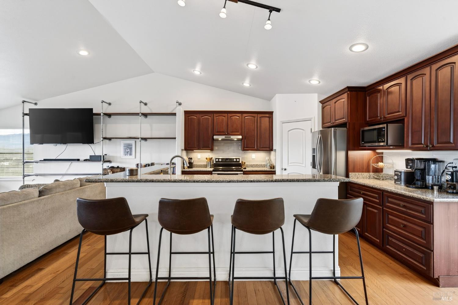 17437 Greenridge Road Hidden Valley Lake, CA 95467 - Photo 27 of 54 a kitchen with stainless steel appliances granite countertop a stove a sink a stove a refrigerator with white cabinets and chairs