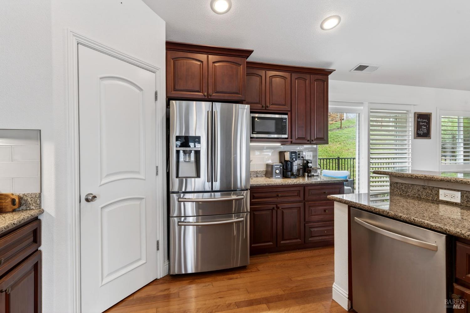 17437 Greenridge Road Hidden Valley Lake, CA 95467 - Photo 29 of 54 a kitchen with stainless steel appliances granite countertop a refrigerator stove and sink