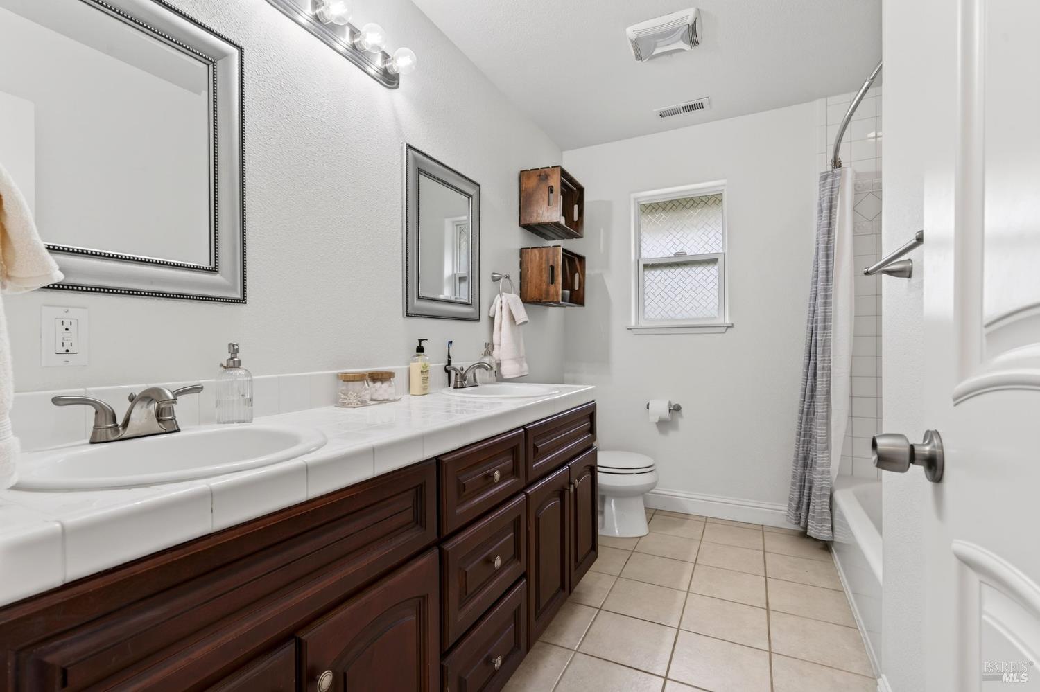 17437 Greenridge Road Hidden Valley Lake, CA 95467 - Photo 42 of 54 a spacious bathroom with a double vanity sink a mirror and a toilet