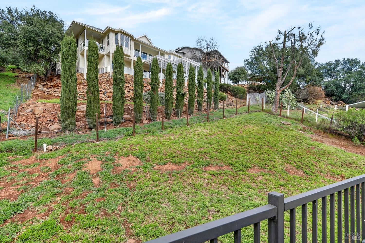 17437 Greenridge Road Hidden Valley Lake, CA 95467 - Photo 51 of 54 a view of a garden with a building in the background